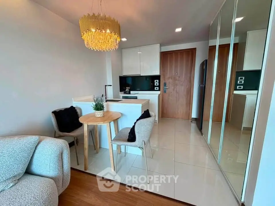 Modern open-plan living room with chic dining area and stylish kitchen in a cozy apartment.