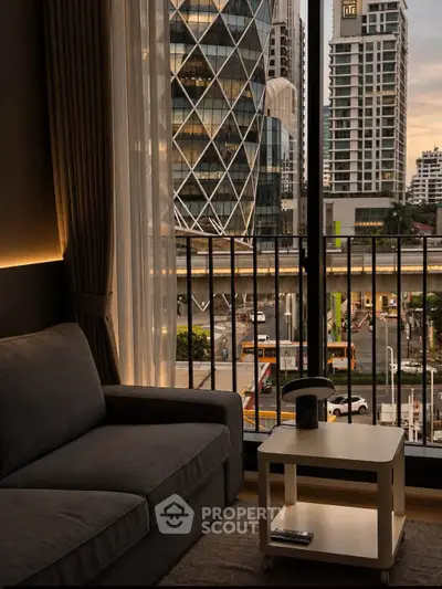 Modern living room with city view from balcony, featuring cozy sofa and stylish decor.