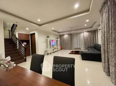 Spacious living room with modern decor and elegant lighting