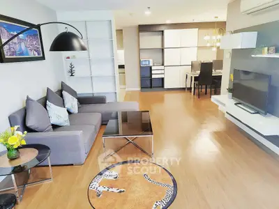 Spacious modern living room with elegant decor and open layout, featuring stylish furniture and bright ambiance.