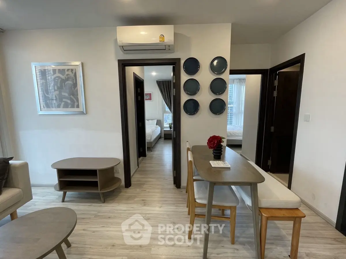 Modern apartment interior with stylish decor and open layout, featuring a cozy dining area and comfortable living space.