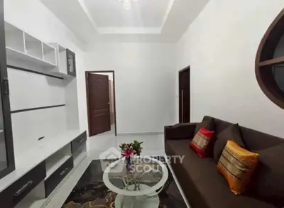 Charming living room with modern decor and cozy seating in a stylish apartment.