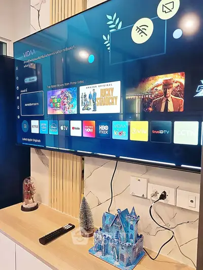 Modern living room with smart TV and stylish decor, featuring a sleek entertainment setup.