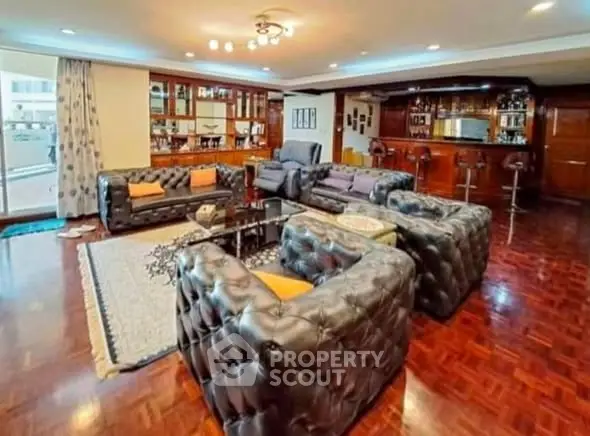 Luxurious living room with elegant leather sofas and stylish bar area