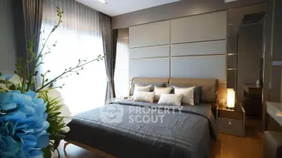 Luxurious bedroom with elegant decor and large window for natural light
