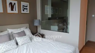 Modern bedroom with stylish decor and large window for natural light