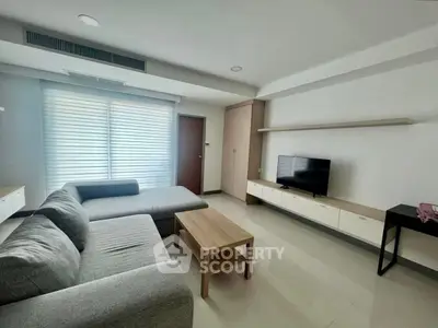 Modern living room with sleek furniture and natural light, perfect for relaxation and entertainment.