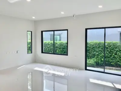 Spacious modern living room with large windows and garden view