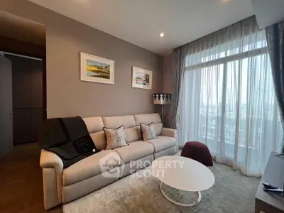Modern living room with large window and stylish decor in a high-rise apartment.