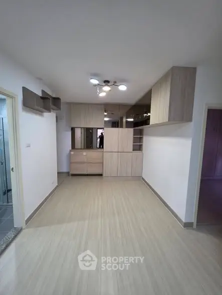 Spacious living room with modern cabinetry and sleek flooring