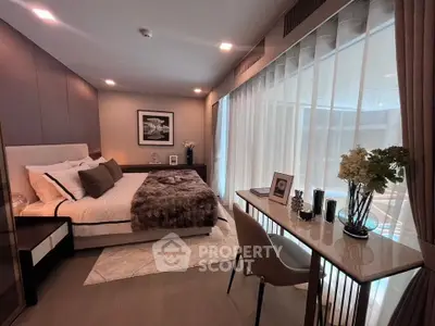 Luxurious bedroom with elegant decor and large window offering natural light