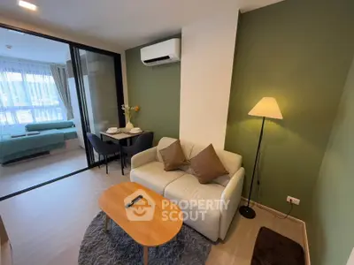 Modern living room with cozy sofa, dining area, and air conditioning in stylish apartment.