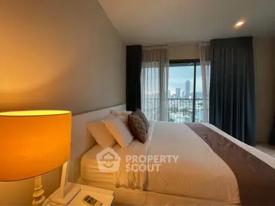 Luxurious bedroom with city view, elegant decor, and cozy ambiance in a high-rise apartment.