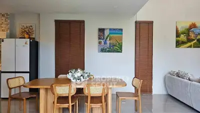 Charming open-layout dining area with wooden furniture and modern decor