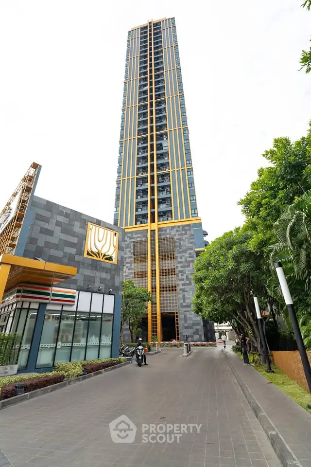 Stunning modern high-rise building with sleek design and lush greenery, perfect for urban living.