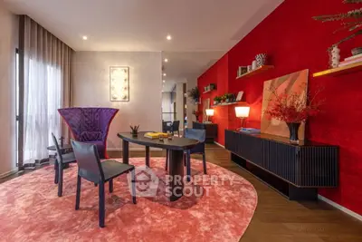 Stylish modern living room with vibrant red accent wall and elegant furniture.