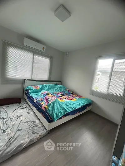 Cozy bedroom with modern decor and ample natural light