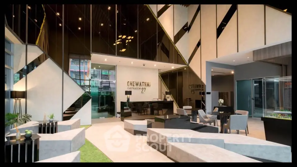Luxurious modern lobby with stylish decor and seating at Chewathai Residence.