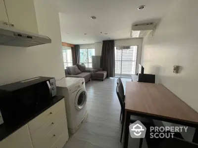 Spacious modern apartment with open layout kitchen featuring state-of-the-art appliances, ample natural light, and a cozy living area perfect for relaxation and entertaining guests.