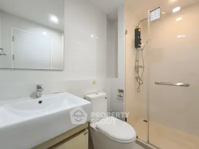 Modern bathroom with sleek fixtures and glass shower enclosure