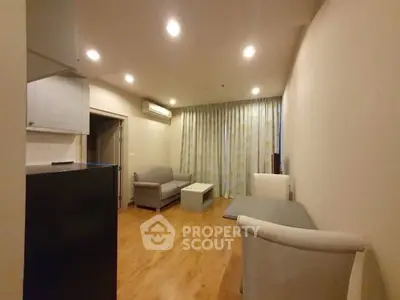 Spacious living room with modern furniture and wooden flooring in a cozy apartment.