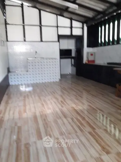 Spacious kitchen with sleek tile flooring and modern design, perfect for culinary enthusiasts.