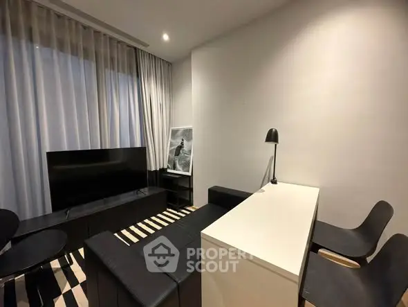 Modern living room with sleek black furniture and stylish decor