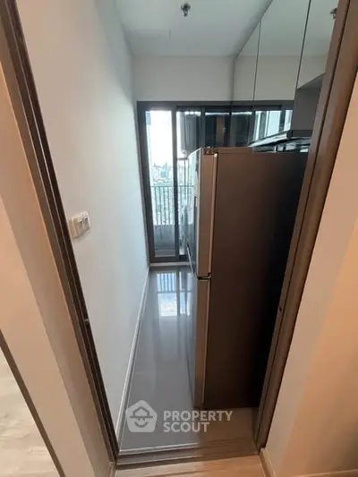 Compact kitchen with modern fridge and balcony view