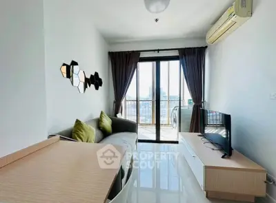 Modern living room with balcony view, stylish decor, and natural light.