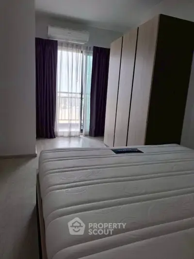 Modern bedroom with large wardrobe and balcony access