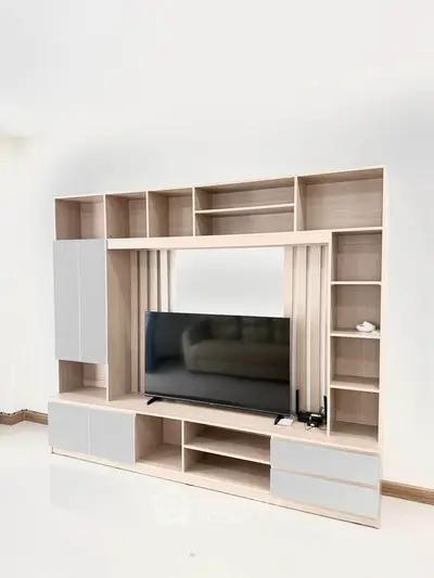 Modern living room with sleek TV unit and ample storage space
