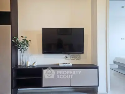 Modern living room with wall-mounted TV and stylish cabinet