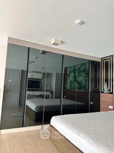 Modern bedroom with mirrored wardrobe and stylish decor