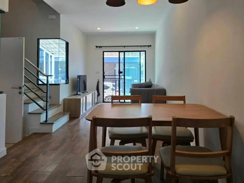 Spacious open-plan living and dining area with modern furnishings and natural light.