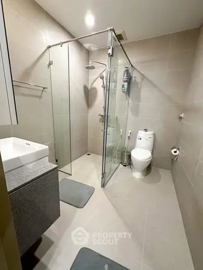 Modern bathroom with glass shower and sleek fixtures