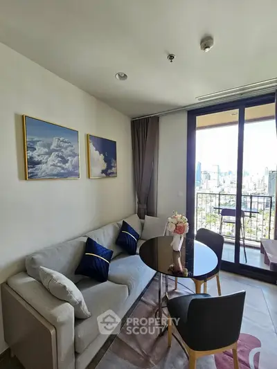 Chic living room with city view balcony, modern decor, and cozy seating area.