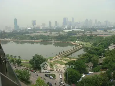 Stunning cityscape view overlooking a serene lake and lush greenery, perfect for urban living enthusiasts.