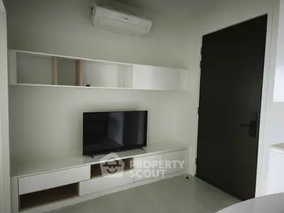Modern living room with sleek TV unit and air conditioning, perfect for cozy entertainment.