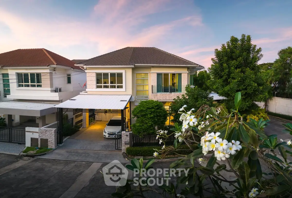 Charming suburban house with lush greenery and a serene atmosphere at sunset.