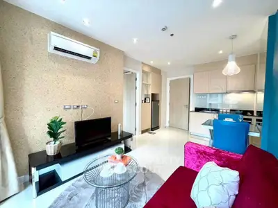 Modern living room with stylish decor and open kitchen layout in a bright apartment.