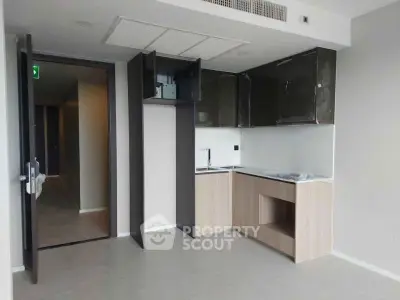 Modern kitchen with sleek cabinetry and open layout in a new apartment.