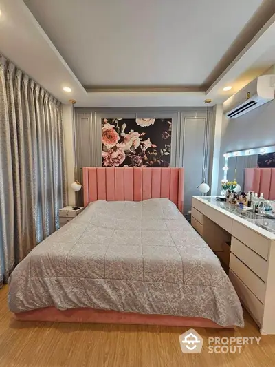 Luxurious bedroom with elegant decor and floral accent wall, featuring a plush bed and modern vanity.