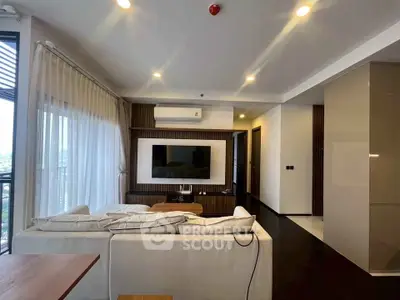 Modern living room with sleek design and large TV, featuring elegant lighting and spacious layout.