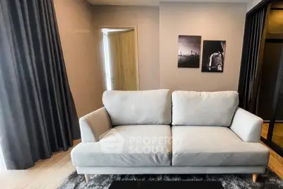 Modern living room with stylish sofa and artistic wall decor in a cozy apartment.