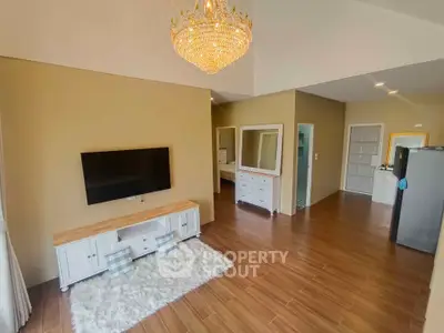 Spacious living room with elegant chandelier and modern decor