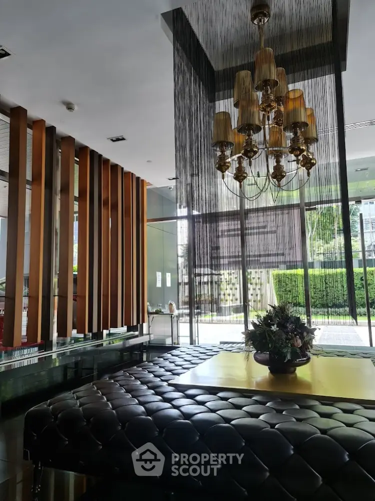Luxurious modern lobby with elegant chandelier and stylish decor