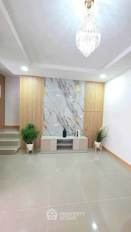 Elegant modern living room with marble accent wall and stylish lighting