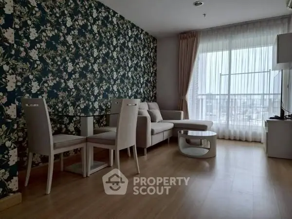 Stylish living room with floral accent wall and modern furniture, featuring a cozy seating area and dining space.