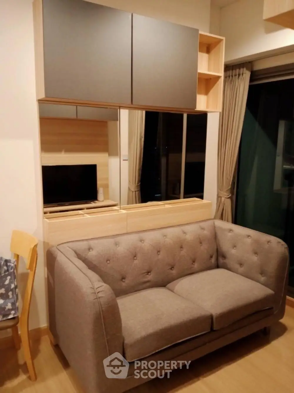 Modern living room with stylish sofa and wall-mounted storage cabinets