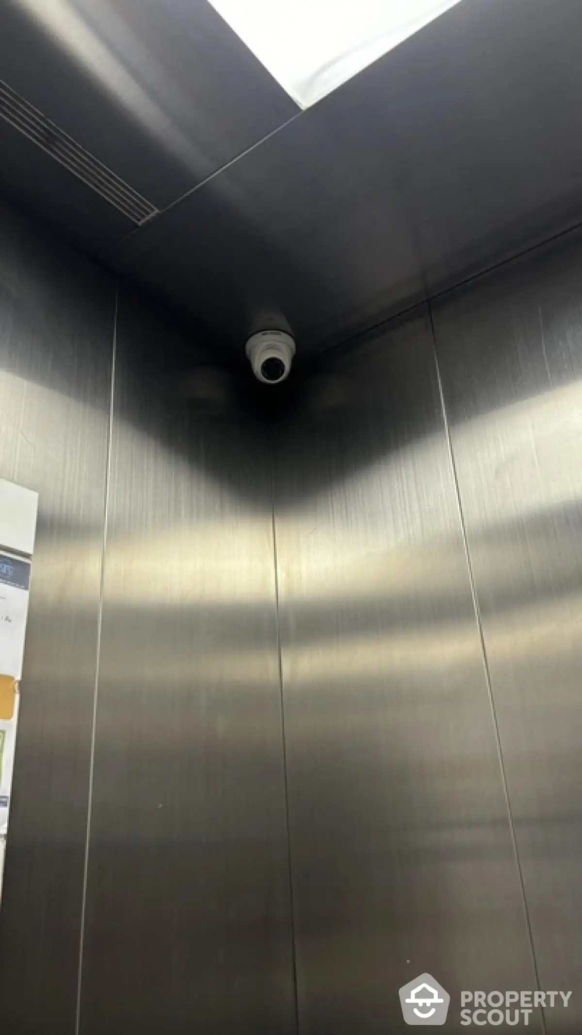 Modern elevator interior with security camera in sleek building